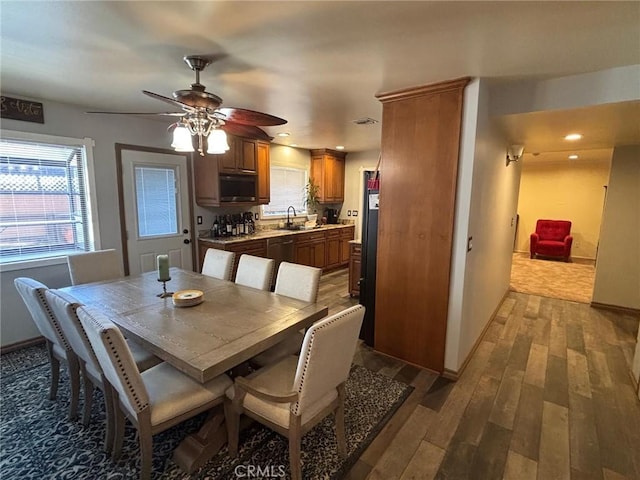 dining area with ceiling fan, sink, and light hardwood / wood-style flooring