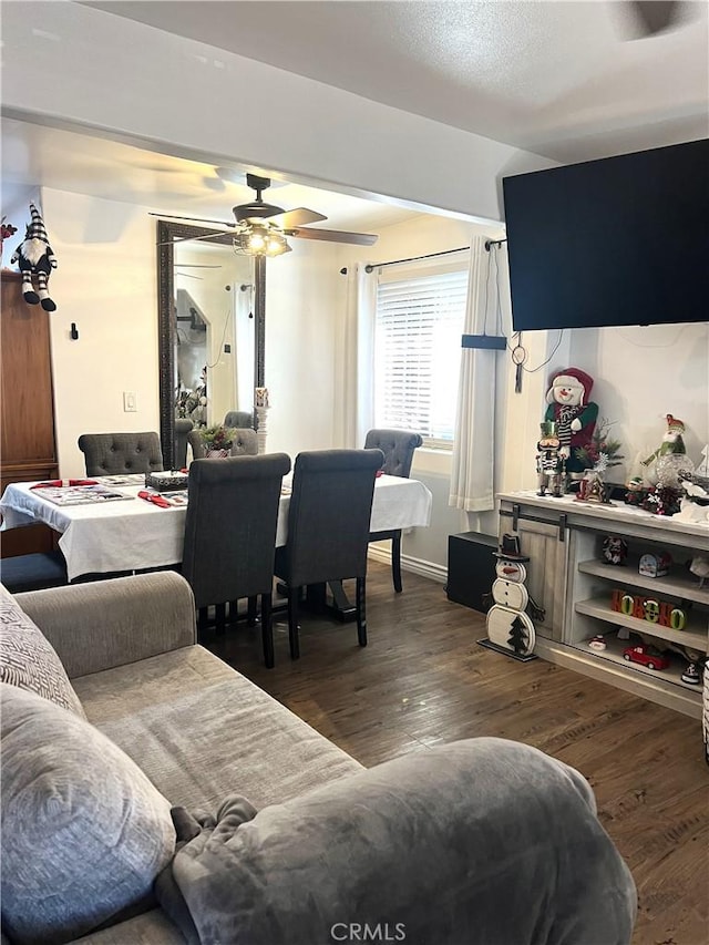 living room featuring dark hardwood / wood-style flooring and ceiling fan