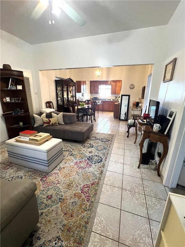 living room featuring ceiling fan and light tile patterned flooring