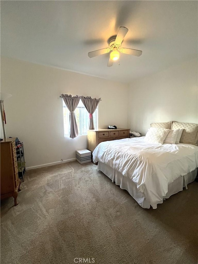 bedroom with ceiling fan and light carpet