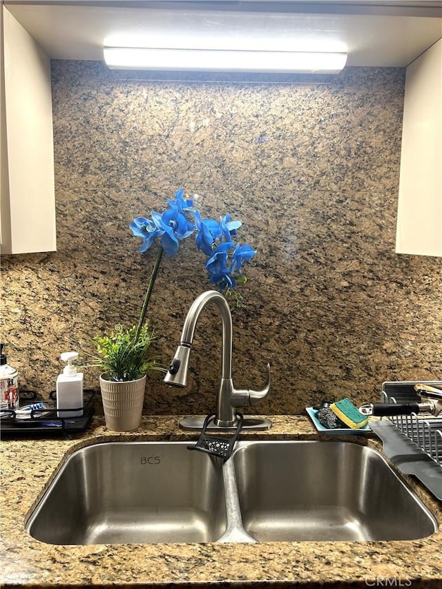 room details with dark stone countertops and sink