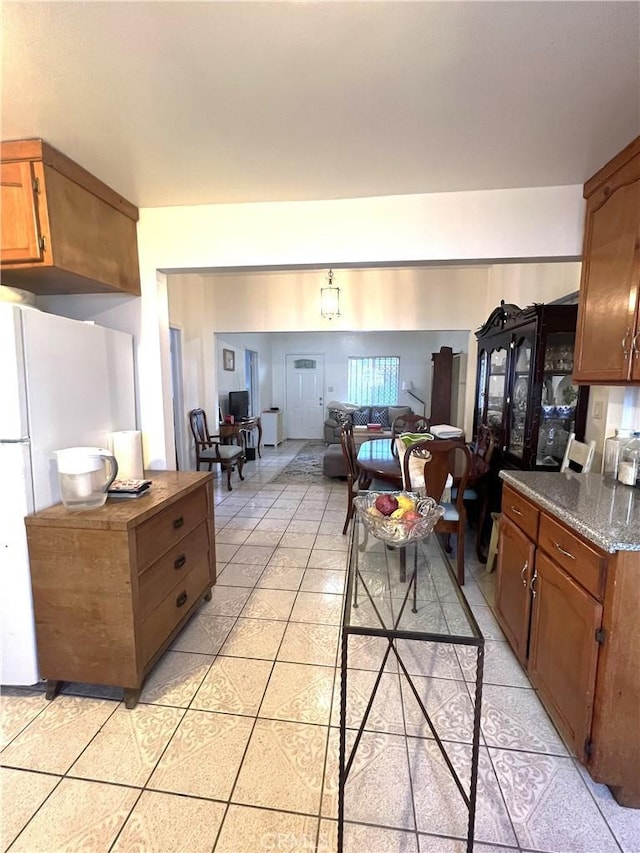 kitchen featuring white refrigerator and light tile patterned flooring