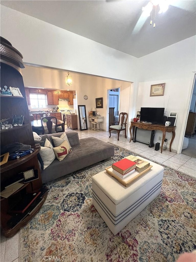 living room featuring ceiling fan and light tile patterned floors