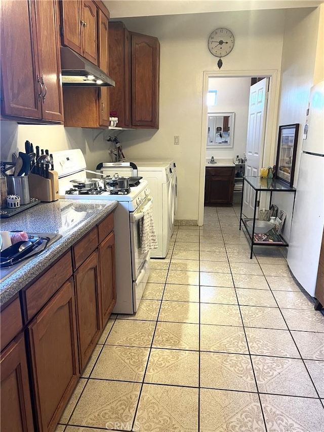 kitchen featuring light tile patterned floors and white appliances