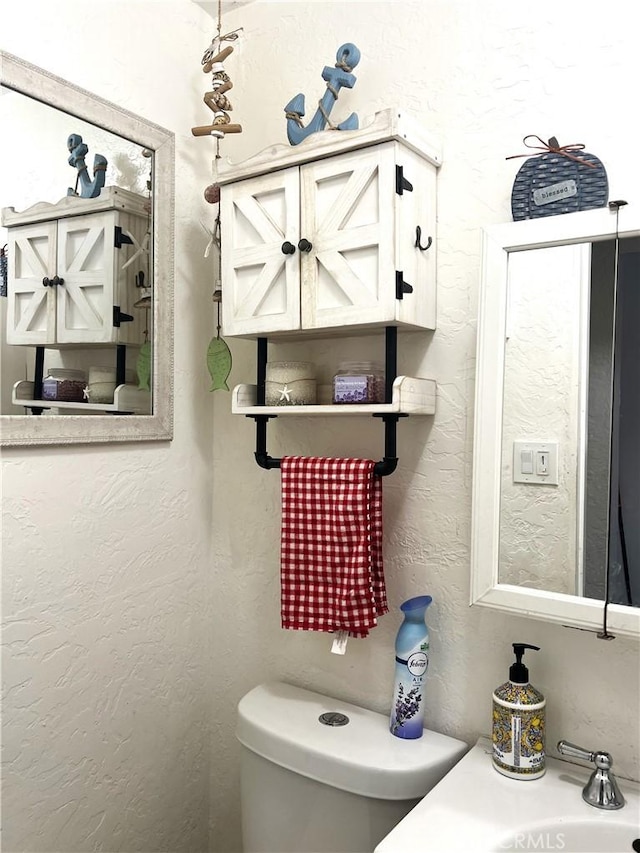 bathroom featuring toilet and sink