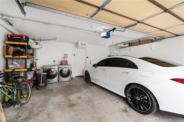 garage with a garage door opener and washing machine and dryer