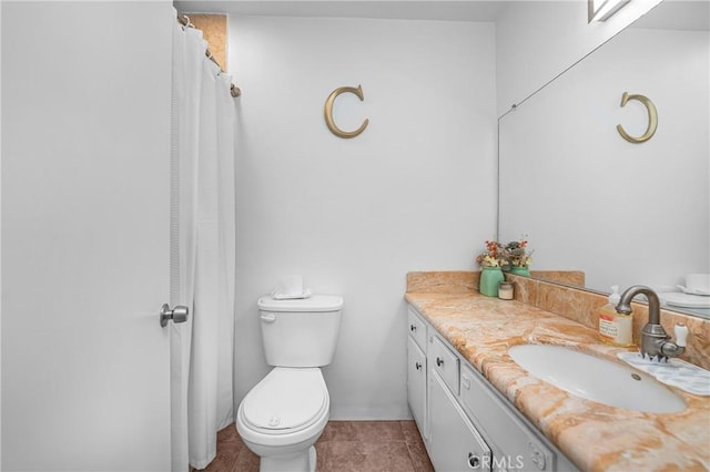 bathroom featuring vanity, tile patterned flooring, and toilet