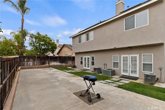 back of house featuring french doors, a patio, and central AC