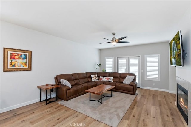 living room with ceiling fan and light hardwood / wood-style floors