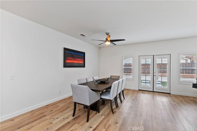 dining room featuring ceiling fan, light wood-type flooring, and french doors