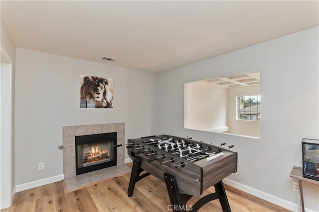 rec room featuring a fireplace and hardwood / wood-style flooring