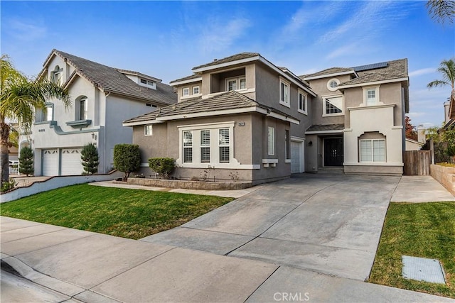 view of front of home featuring solar panels, a garage, and a front lawn