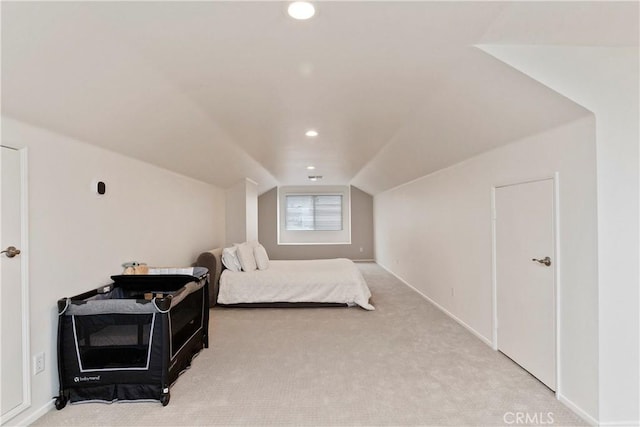 carpeted bedroom featuring lofted ceiling