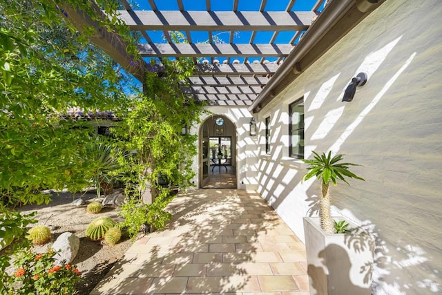 property entrance with a pergola