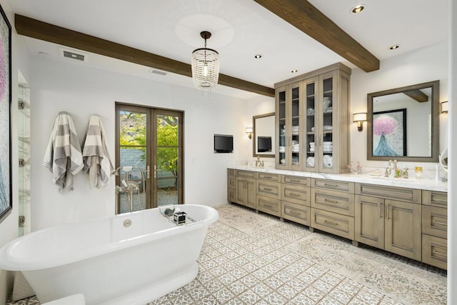 bathroom with a washtub, beam ceiling, vanity, and an inviting chandelier