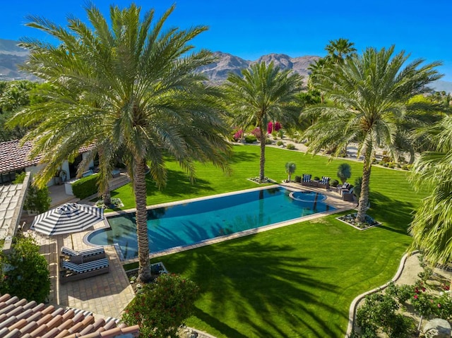 view of pool with a mountain view and a patio area