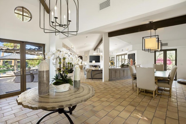 dining space with beamed ceiling, high vaulted ceiling, and an inviting chandelier