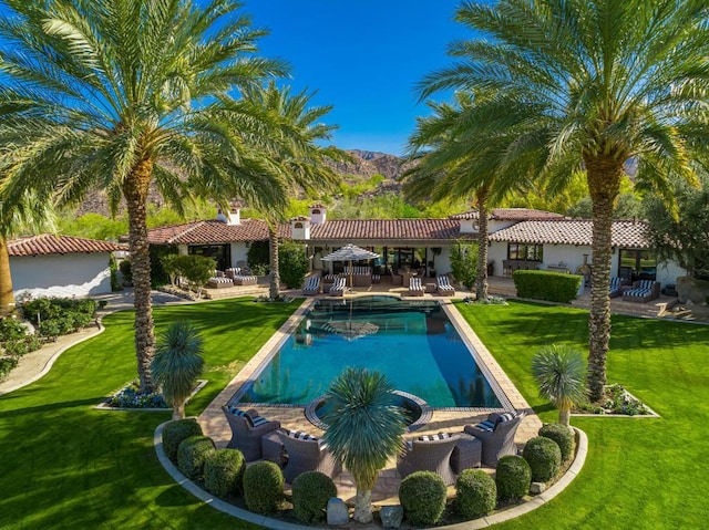 view of swimming pool featuring a yard and a patio