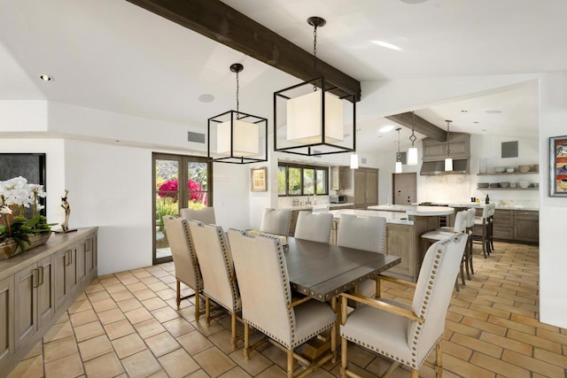 dining area with vaulted ceiling with beams