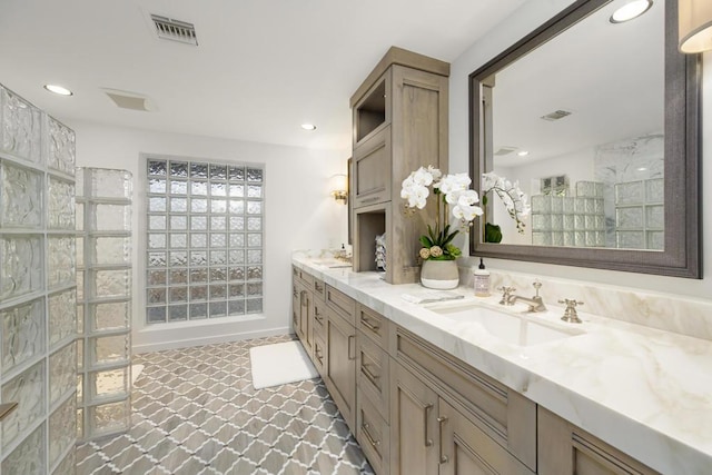 bathroom with vanity and a shower