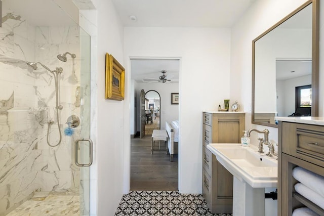 bathroom with ceiling fan, sink, wood-type flooring, and an enclosed shower