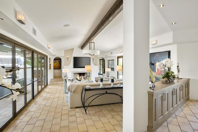 tiled living room with vaulted ceiling with beams