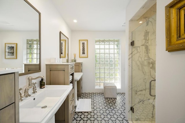 bathroom featuring vanity, an enclosed shower, and a healthy amount of sunlight