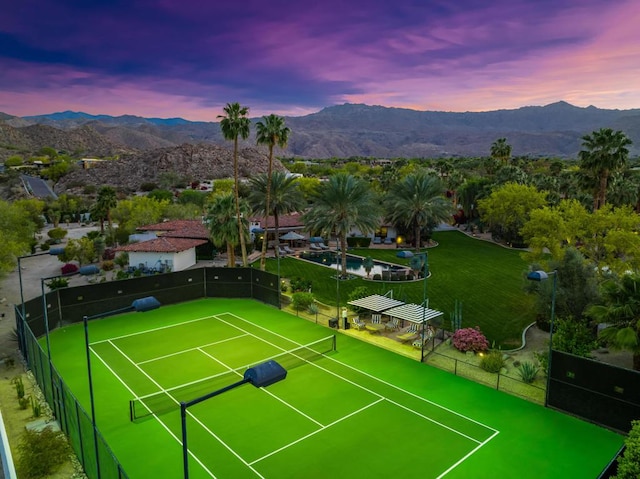 view of tennis court with a mountain view