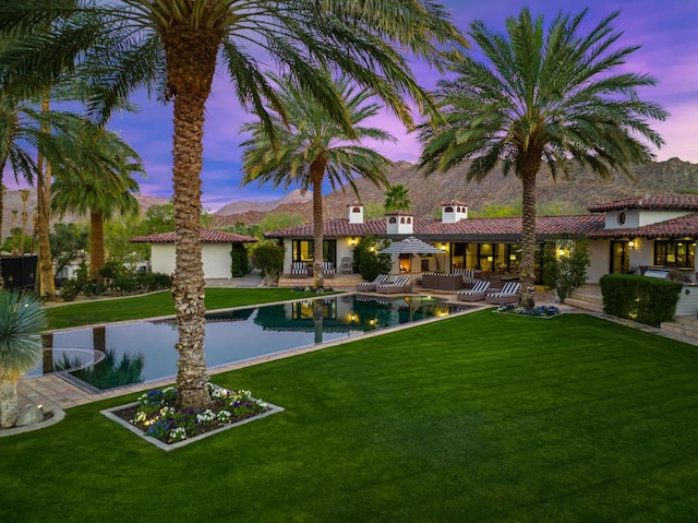 exterior space featuring outdoor lounge area, a patio area, and a lawn