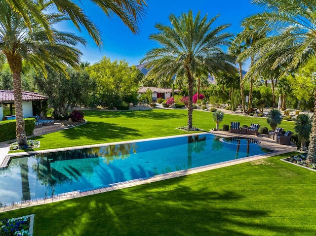 view of swimming pool featuring a patio area and a yard