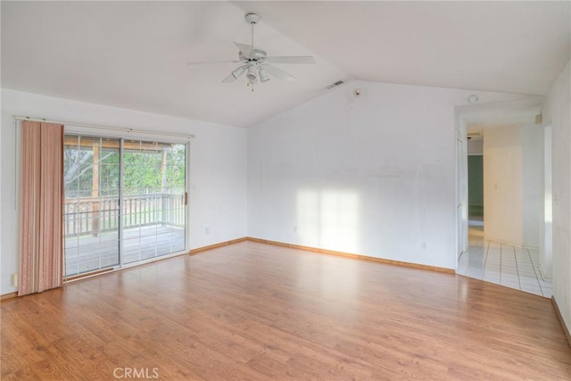 spare room with light hardwood / wood-style floors, ceiling fan, and lofted ceiling