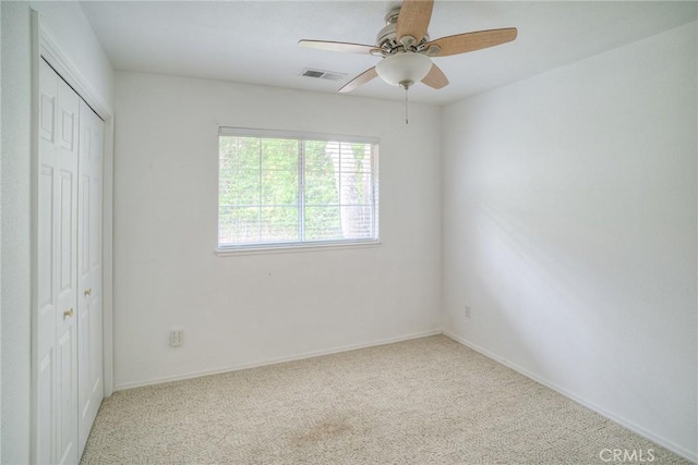 carpeted empty room with ceiling fan