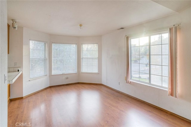 unfurnished dining area with light wood-type flooring