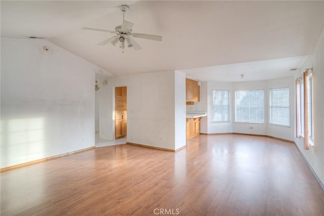 unfurnished living room with light wood-type flooring, vaulted ceiling, and ceiling fan