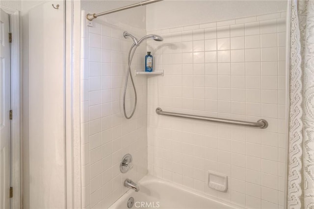 bathroom with shower / bathtub combination with curtain