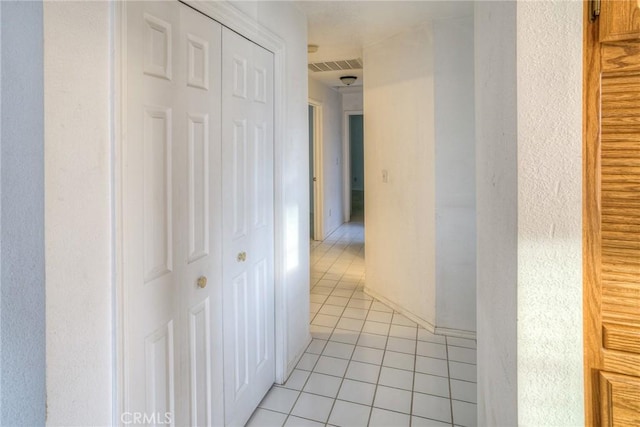 hall with light tile patterned floors