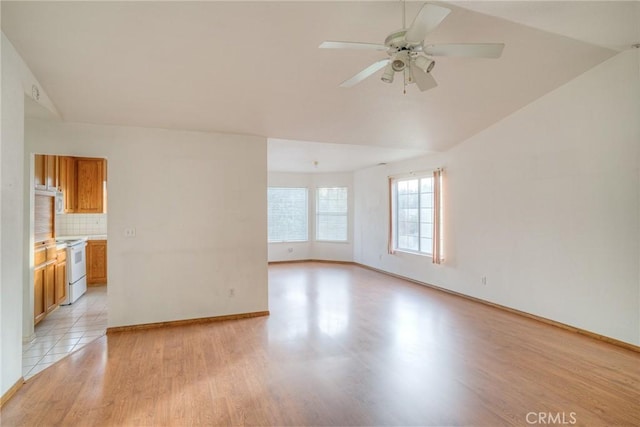 unfurnished living room with ceiling fan, light hardwood / wood-style flooring, and lofted ceiling