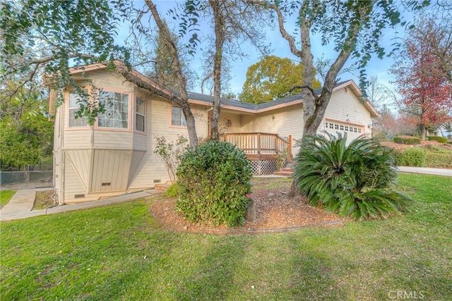 view of front of home featuring a garage, a wooden deck, and a front lawn