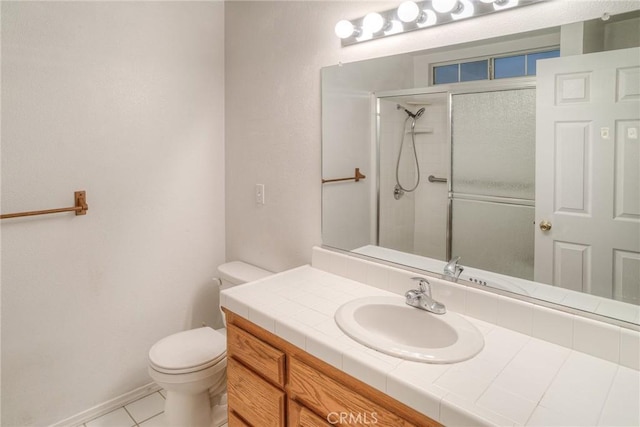 bathroom featuring tile patterned flooring, vanity, an enclosed shower, and toilet