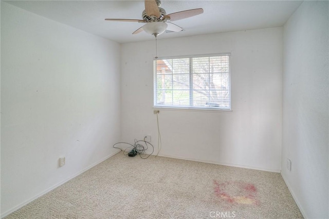 carpeted empty room featuring ceiling fan