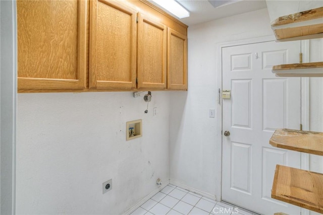 laundry room with electric dryer hookup, hookup for a washing machine, light tile patterned floors, and cabinets