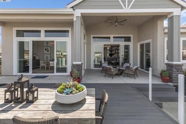 deck with an outdoor hangout area and ceiling fan