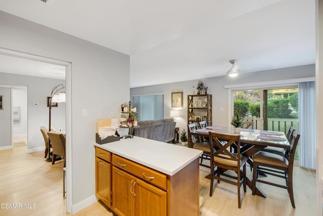 kitchen featuring ceiling fan, kitchen peninsula, and light hardwood / wood-style flooring