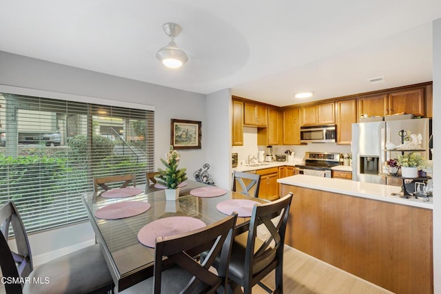 kitchen with sink, appliances with stainless steel finishes, and light wood-type flooring