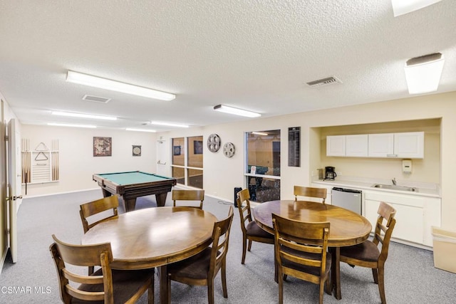 dining area featuring light carpet, billiards, and a textured ceiling