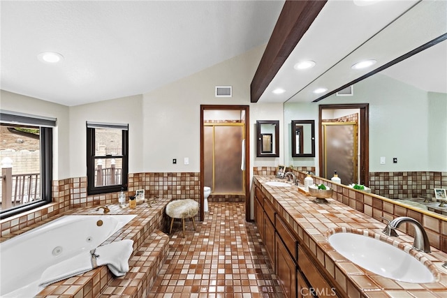 bathroom with vanity, a bathtub, toilet, and vaulted ceiling