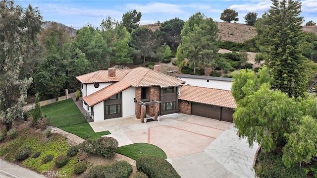 view of front of home with a garage and a front lawn