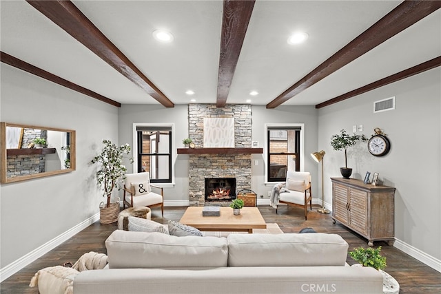 living room featuring beam ceiling, a stone fireplace, and dark wood-type flooring