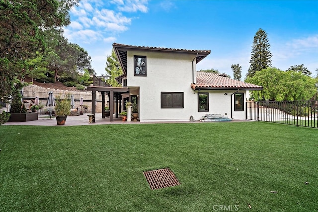 back of property featuring a lawn and a patio