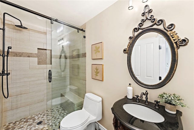 bathroom with toilet, an enclosed shower, and sink